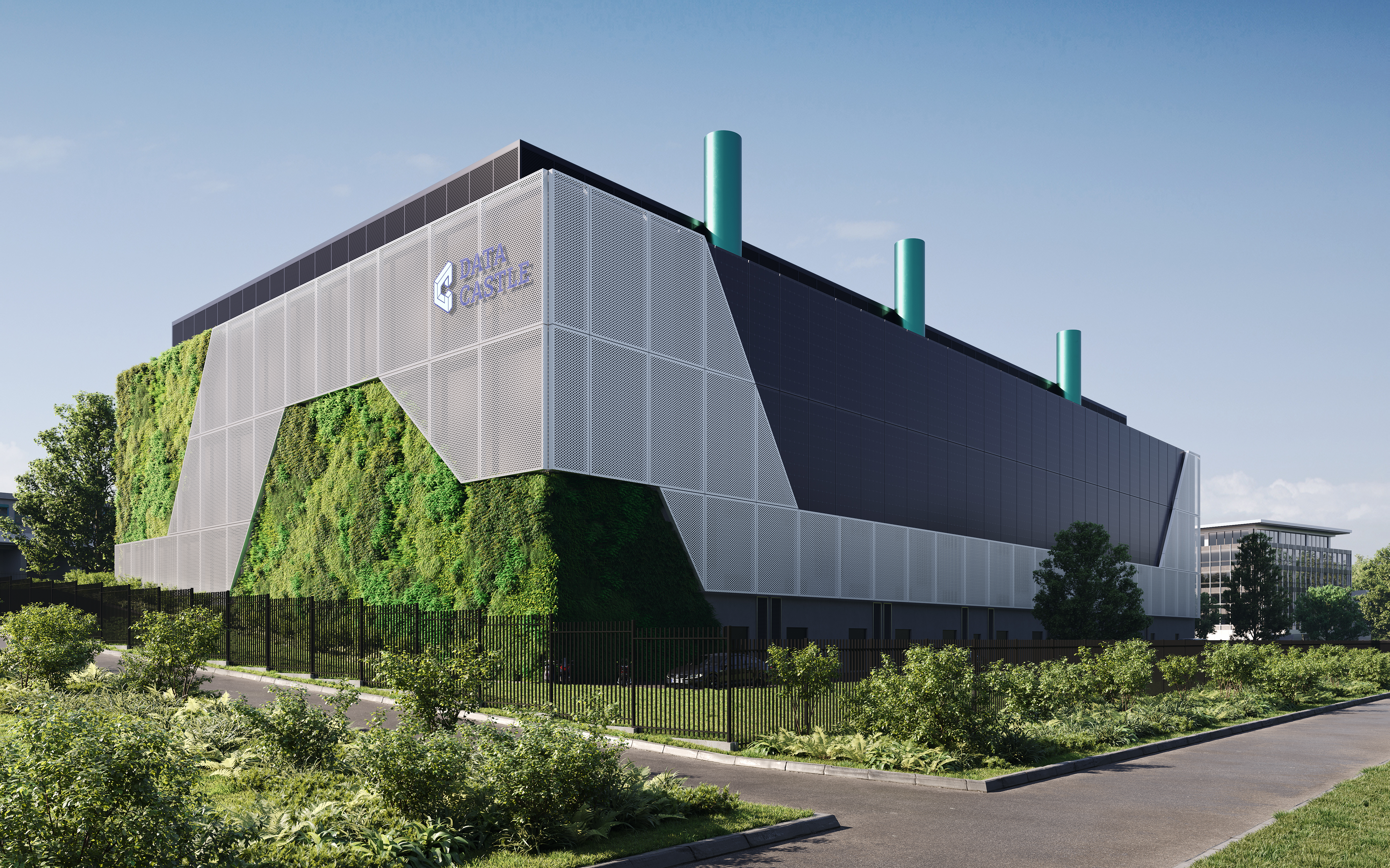 Modern data center building exterior with glass windows, landscaped grounds, parking area, and trees